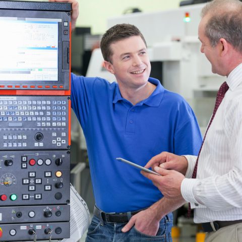 engineers-discussing-automated-machinery-with-tabl-2026-03-26-08-35-52-utc